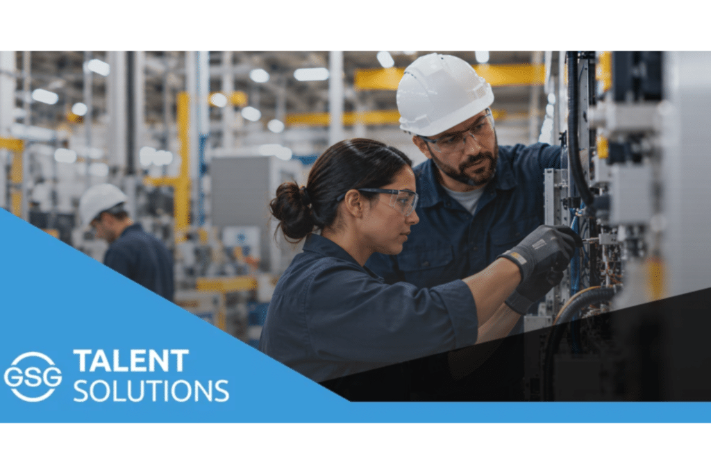 Skilled manufacturing technicians inspecting and troubleshooting industrial equipment in a modern production facility.